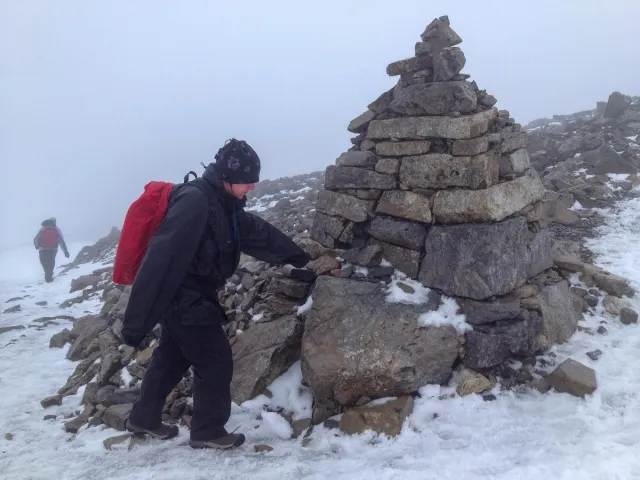 Karin at a marking on the way to the summit in the first snow